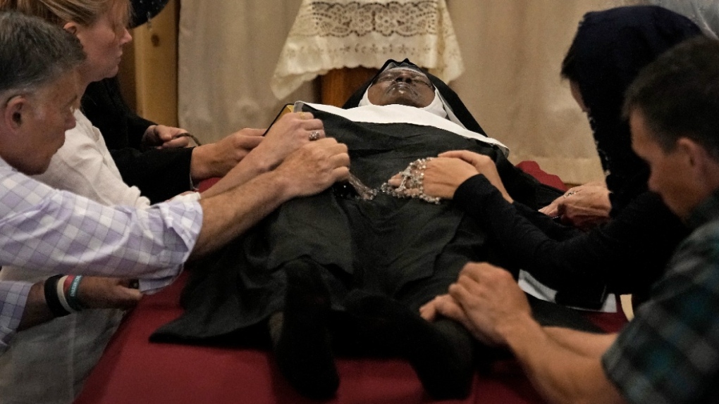 Praying over Sister Wilhelmina Lancaster's body
