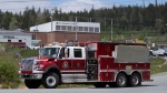 Firefighters with Halifax Regional Fire and Emergency leave a staged command centre within the evacuated zone of the wildfire burning in Tantallon, N.S., outside of Halifax on Monday, May 29, 2023. THE CANADIAN PRESS/Darren Calabrese