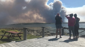 Residents look towards the smoke from a wildfire in Shelburne County, N.S., on May 30, 2023. (Jonathan MacInnis/ CTV Atlantic)