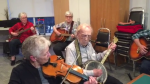 Carm Colvin (centre) is seen leading a jam session on his banjo at 104-years-old (Submitted Photo: Bill Bunka)