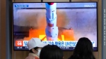 A TV screen shows a file image of North Korea's rocket launch during a news program at the Seoul Railway Station in Seoul, South Korea, Monday, May 29, 2023. (AP Photo/Ahn Young-joon) 