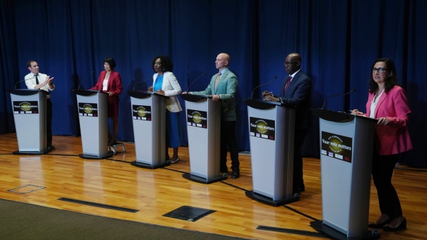 Josh Matlow (left) applauds a comment from Mitzie Hunter (centre left) as they are joined on stage by Olivia Chow (second left) Brad Bradford (centre right) Mark Saunders (second right) and Ana Bailao (right) at a Toronto Mayoral Candidates debate in Scarborough, Ont. on Wednesday, May 24, 2023. THE CANADIAN PRESS/Chris Young
