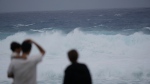 Watching waves affected by a severe weather system in Itoman, southern Japan, on May 31, 2023. (Hiro Komae / AP) 