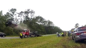 Car goes up truck and flips in the air