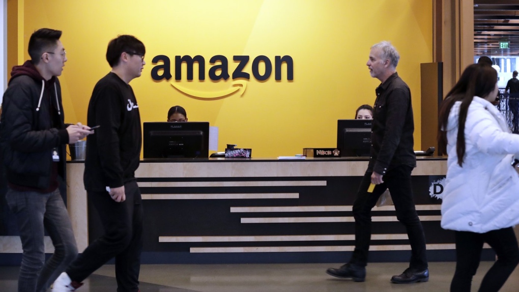 Employees walk through a lobby at Amazon's hq