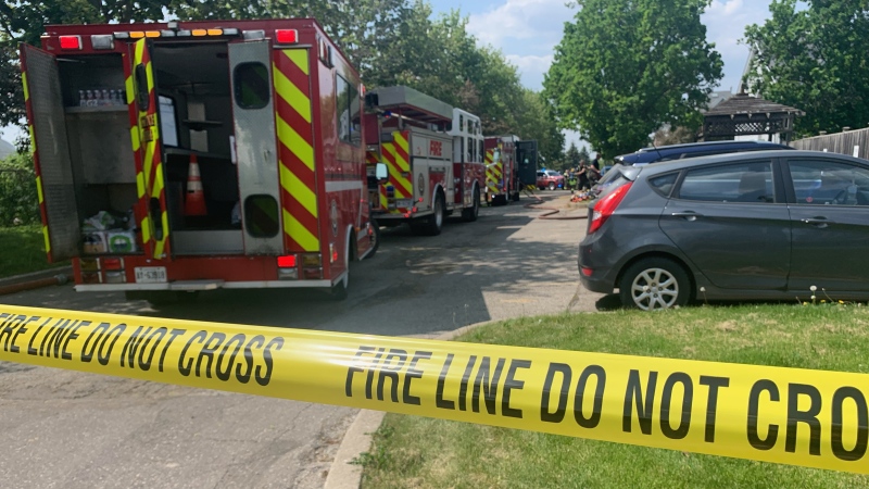 Around six fire trucks, including an aerial truck, are on scene at a fire on Grand Valley Drive in Kitchener. (Krista Sharpe/CTV News)