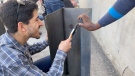 Mohammad Maarefi prepares a mold for concrete as he learns how to make a biosand filter from scratch.