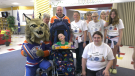 Karter Bourgeault and his family along with Edmonton Oilers mascot Hunter at a fundraiser at Crawford Plains School on May 31, 2023. (CTV News Edmonton)