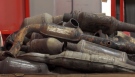 A pile of catalytic converters are seen in Calgary.