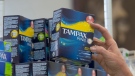 In this June 22, 2016, file photo, Tammy Compton restocks tampons at Compton's Market, in Sacramento, Calif. California public schools and colleges would have to stock their restrooms with free menstrual products under legislation sent to Gov. Gavin Newsom on Thursday, Sept. 9, 2021.(AP Photo/Rich Pedroncelli, File)