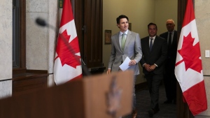 Prime Minister Justin Trudeau, Minister of Public Safety Marco Mendicino (centre) and Minister of Emergency Preparedness Bill Blair arrive to hold a press conference on Parliament Hill in Ottawa on Tuesday, May 23, 2023. (THE CANADIAN PRESS/Sean Kilpatrick)