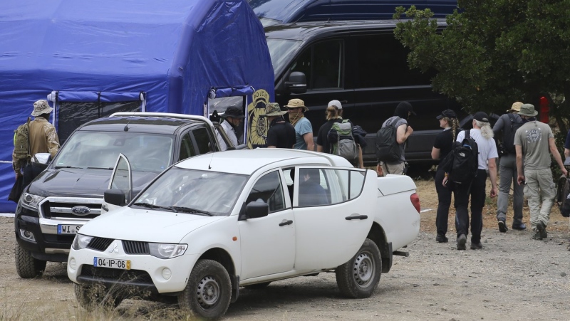 Police search teams arrive back to an operation tent near Barragem do Arade, Portugal, Tuesday May 23, 2023. (AP Photo/Joao Matos, File)