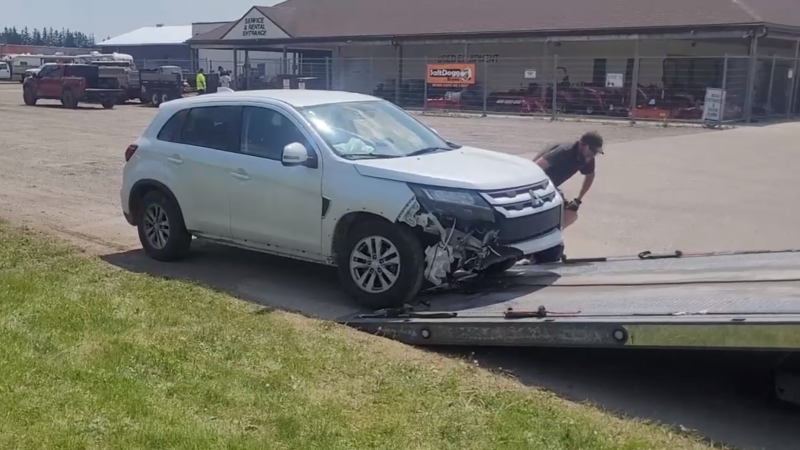 Staff say the men attempted to take off in this car, but lost control trying to exit the parking lot and crashed into a tractor. (Submitted)