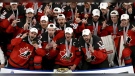 Milan Lucic (front row, far right), celebrates with Flames teammates Tyler Toffoli (captain) and MacKenzie Weegar after winning a gold medal for Canada at the World Hockey Championships. (Photo: Twitter@HockeyCanada)