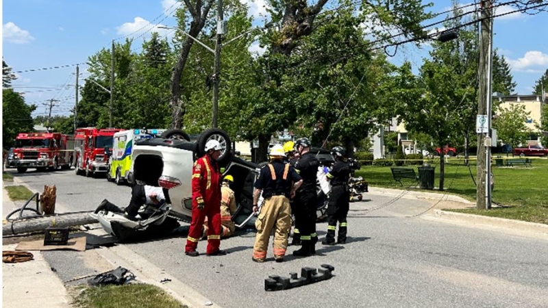 A vehicle flipped onto its roof and a hydro pole snapped onto the road following a collision in Bracebridge, Ont., on Thurs., June 1, 2023. (OPP)