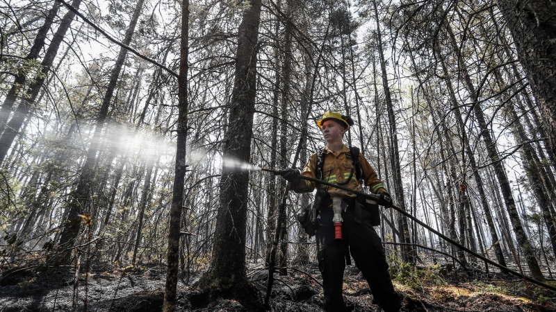 Department of Natural Resources and Renewables firefighter Kalen MacMullin of Sydney, N.S. works on a fire in Shelburne County, N.S. in a Thursday, June 1, 2023 handout photo. THE CANADIAN PRESS/HO-Communications Nova Scotia
