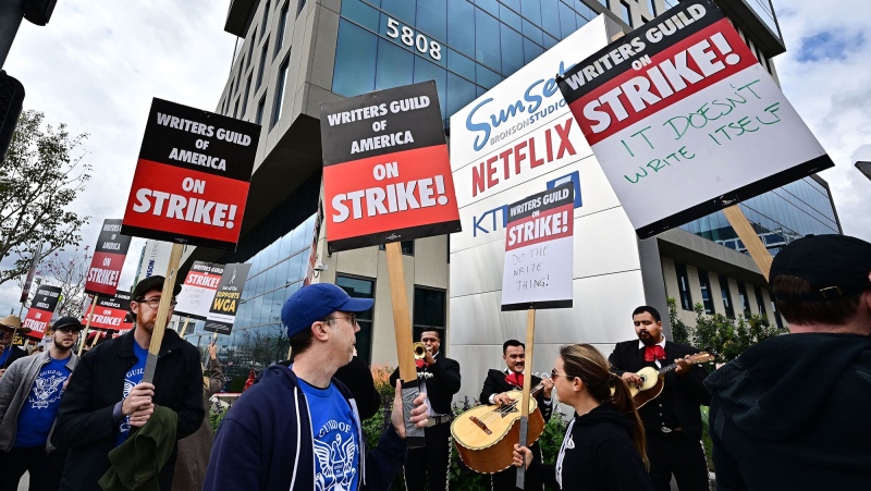 Writers on strike march with signs on the picket line on day four of the strike by the Writers Guild of America in front of Netflix in Hollywood, California on May 5. (Frederic J. Brown/AFP/Getty Images)
