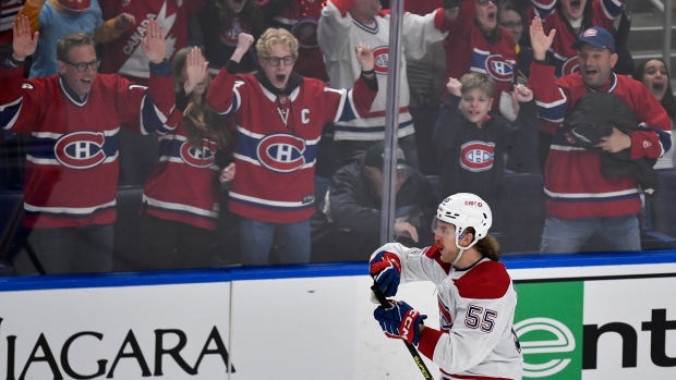 Montreal Canadiens left wing Michael Pezzetta (55) celebrates in front of Montreal fans after scoring the winning goal against the Buffalo Sabres during a shootout of an NHL hockey game in Buffalo, N.Y., Monday, March 27, 2023. (AP Photo/Adrian Kraus)