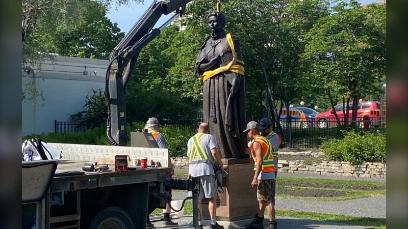 Workers reinstall a statue of Queen Elizabeth II, that was toppled on Canada Day 2021, on the grounds of the Manitoba legislature in Winnipeg on Friday June 2, 2023. THE CANADIAN PRESS/Steve Lambert