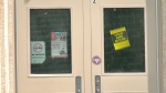 A hold and secure sign is posted on the door of École Riverview School in Winnipeg on June 2, 2023. (Source: Scott Andersson/CTV News Winnipeg)