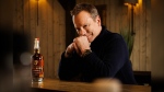 Hollywood actor Kiefer Sutherland is pictured in a promotional photo with his new liquor brand Red Bank Whisky.