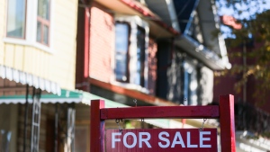 A real estate sign is displayed in front of a house in the Riverdale area of Toronto on Wednesday, September 29, 2021. THE CANADIAN PRESS/Evan Buhler