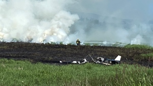 This photo shows firefighters working to put out a fire that broke out on a small plane in Surrey on Friday, June 2, 2023. 