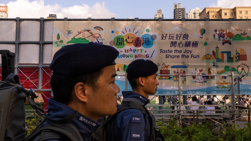 Police officers from the counter-terrorism unit patrol outside Victoria Park, the city's site for the annual Tiananmen massacre vigil, in Hong Kong, June 3, 2023. (AP Photo/Louise Delmotte)