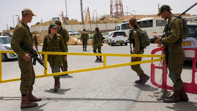 Israeli soldiers secure a gate leading to a military base following a deadly shootout in southern Israel along the Egyptian border, June 3, 2023. (AP Photo/Tsafrir Abayov)