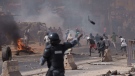 Riot police throw a tear gas canister at demonstrators during a protest at a neighbourhood in Dakar, Senegal, June 2, 2023. (AP Photo/Leo Correa)