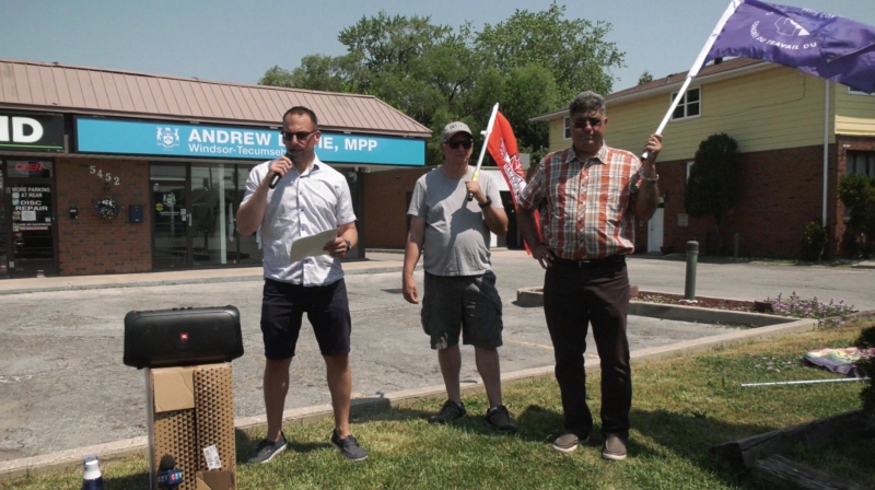 Community members and labour representatives rally outside Windsor-Tecumseh PC MPP Andrew Dowie’s office on June 3, 2023. (Rich Garton/CTV News Windsor)