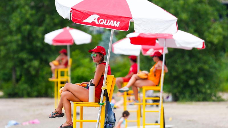 Lifeguards work at Brittany Beach of the Ottawa River in Ottawa on Friday, June 24, 2022. Municipalities across Canada are grappling with lifeguard shortages as city pools and beaches open for the summer. THE CANADIAN PRESS/Sean Kilpatrick