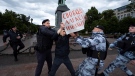 Police officers detain a demonstrator with a poster that reads: "Freedom for Alexei Navalny", in Pushkinskaya Square in Moscow, Russia, Sunday, June 4, 2023. (AP Photo)