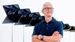 Apple CEO Tim Cook stands in front of a display of new Apple MacBook Air computers with M2 processors, Monday, June 6, 2022, following the keynote presentation of Apple's World Wide Developer Conference on the campus of Apple's headquarters in Cupertino, Calif. (AP Photo/Noah Berger)