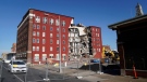An apartment building that partially collapsed two days earlier is seen, May 30, 2023, in Davenport, Iowa. (AP Photo/Erin Hooley)