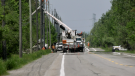 Hydro Ottawa crews repair a damaged hydro pole on Hawthorne Road after a driver hit it early Sunday morning. June 4, 2023. (Shaun Vardon/CTV News Ottawa)