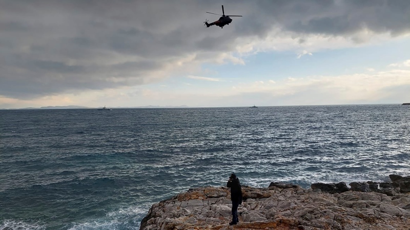 In this file photo provided by the Greek Coast Guard, a helicopter searches over the Aegean Sea near the northwestern island of Lesbos, Greece, Tuesday, Feb. 7, 2023. (Greek Coast Guard via AP)