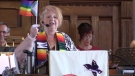Pastor Janice Pow of Norwich United Church waves a pride flag during the Sunday Pride service on June 4, 2023 in Norwich, Ont. (Brent Lale/CTV London)