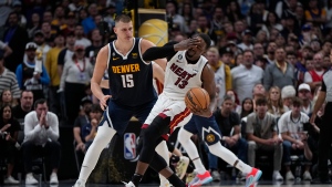 Miami Heat centre Bam Adebayo (13) reacts next to Denver Nuggets centre Nikola Jokic (15) during the second half of Game 2 of basketball's NBA Finals, Sunday, June 4, 2023, in Denver. (AP Photo/Mark J. Terrill)