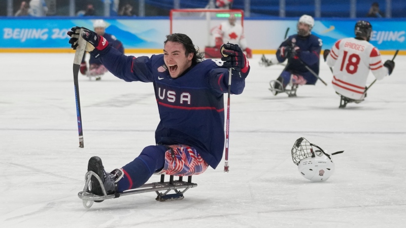 Jack Wallace of the United States celebrates after his team defeated Canada in their para ice hockey gold medal match at the 2022 Winter Paralympics, Sunday, March 13, 2022, in Beijing. (AP Photo/Dita Alangkara)