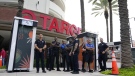 Police officers stand outside a Target store as a group of people protest across the street, Thursday, June 1, 2023, in Miami. (AP Photo/Lynne Sladky, File)
