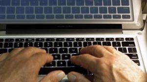 In this Feb. 27, 2013, file photo illustration, hands type on a computer keyboard in Los Angeles. The Nova Scotia government says it is investigating the theft of personal information stolen through a privacy breach to a third-party file transfer system the province was using. THE CANADIAN PRESS/AP-Damian Dovarganes