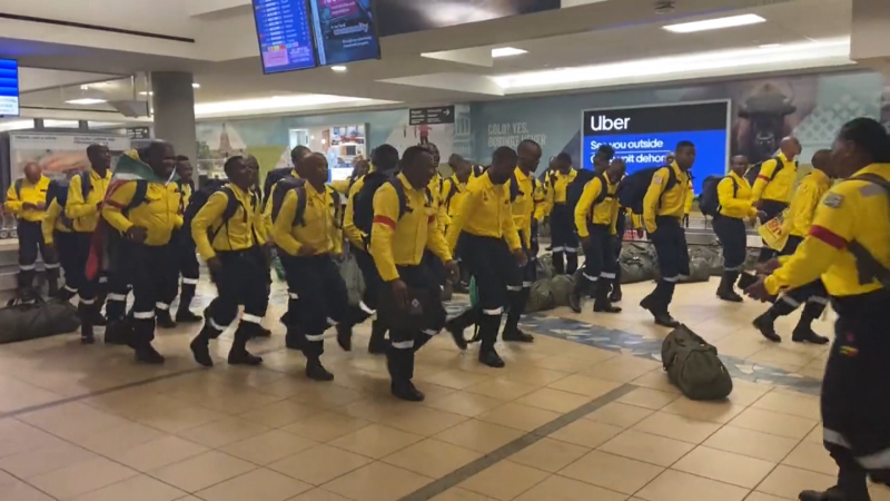 South African firefighters who arrived in Alberta on June 4, 2023, to help fight wildfires, broke out into song and dance at the baggage claim of Edmonton International Airport upon landing. (Source: Twitter / WO-FIRE)