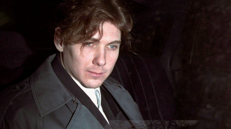 Paul Bernardo sits in the back of a police cruiser as he leaves a hearing in St. Catharines, Ont., April 5, 1994. (THE CANADIAN PRESS/Frank Gunn)
