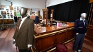 The bar used on the set of the television series "Cheers" and some costumes worn by actors on the sitcom are shown, Thursday, April 27, 2023, in Irving, Texas. (AP Photo/Tony Gutierrez)
