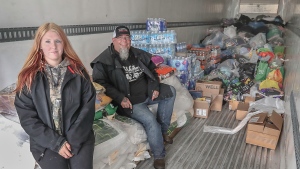 Chris Slauenwhite, right, a trucker who lives near Bridgewater, and his friend Rylee Faulkner gathered donations on the weekend and delivered them to the Shelburne County Agricultural Exhibition grounds. (Communications Nova Scotia)
