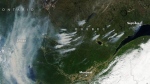 (NASA Earth Observatory image of the Quebec wildfires by Lauren Dauphin, using MODIS data from NASA EOSDIS LANCE and GIBS/Worldview)