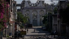 People walk near the ruins of The Cathedral of Our Lady of the Assumption in Port-au-Prince, Haiti, Monday, June 5, 2023. (AP Photo/Ariana Cubillos)