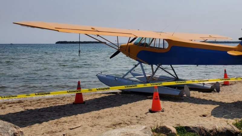 Police tape and pylons surround a plane docked on a beach in Innisfil, Ont., on Sat., June 3, 2023. (Source: South Simcoe Police Services) 