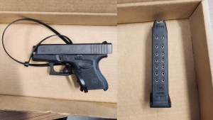 Police say this gun and 9mm magazine were found at the scene of a crash on Highway 401 in North Dumfries Township.(Submitted/OPP)